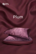 Plum satin pillowcases on a matching plum background, luxury bedding decor