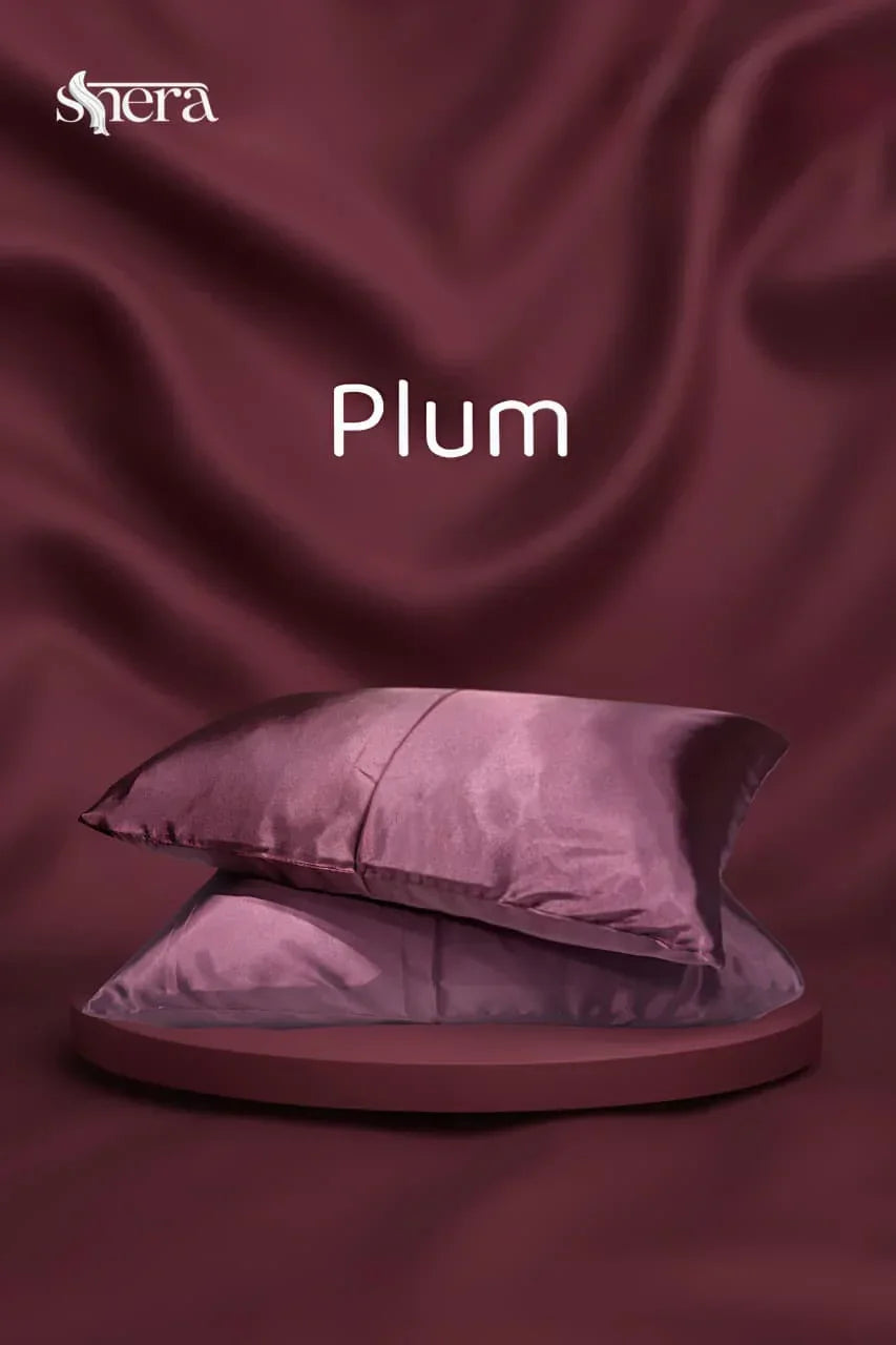 Plum satin pillowcases on a matching plum background, luxury bedding decor