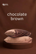 Chocolate brown satin pillowcases stacked on a brown background
